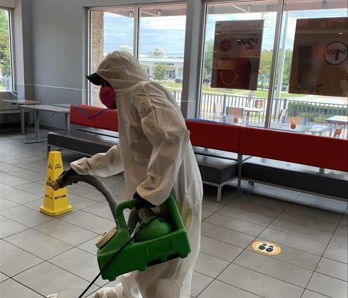 A SERVPRO employee cleaning a McDonald's restaurant.