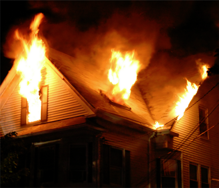 a house with fire blazing out of its windows
