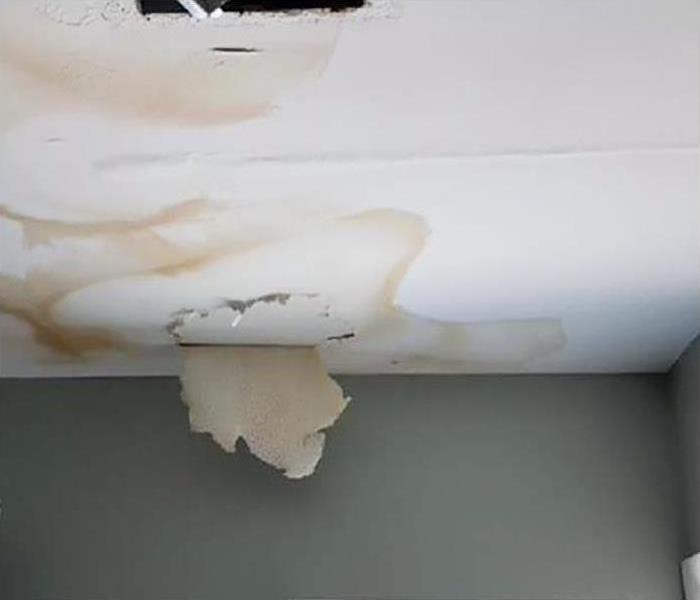 A ceiling with  huge water spot caused by a leak