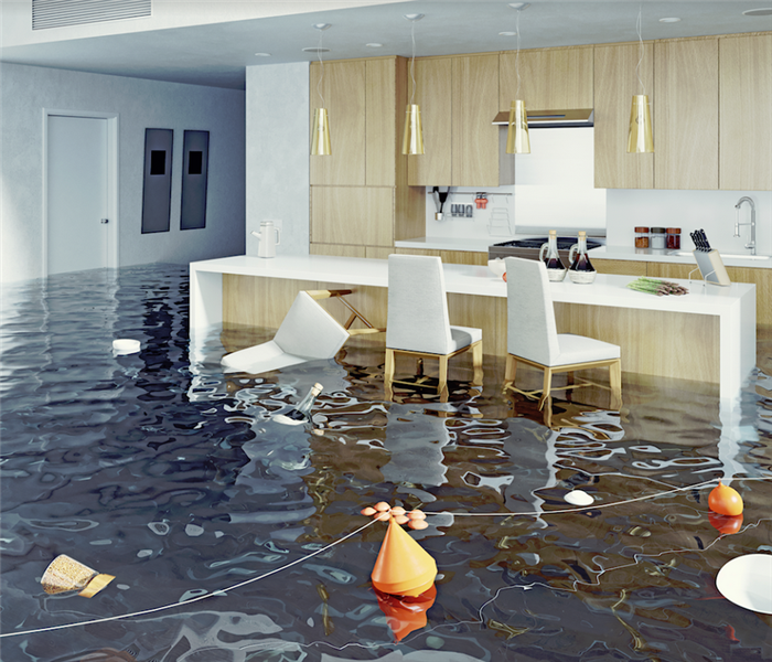 a flooded kitchen with items floating everywhere